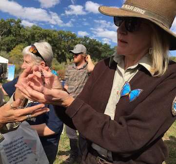 Valle de Oro park ranger holding a butterfly